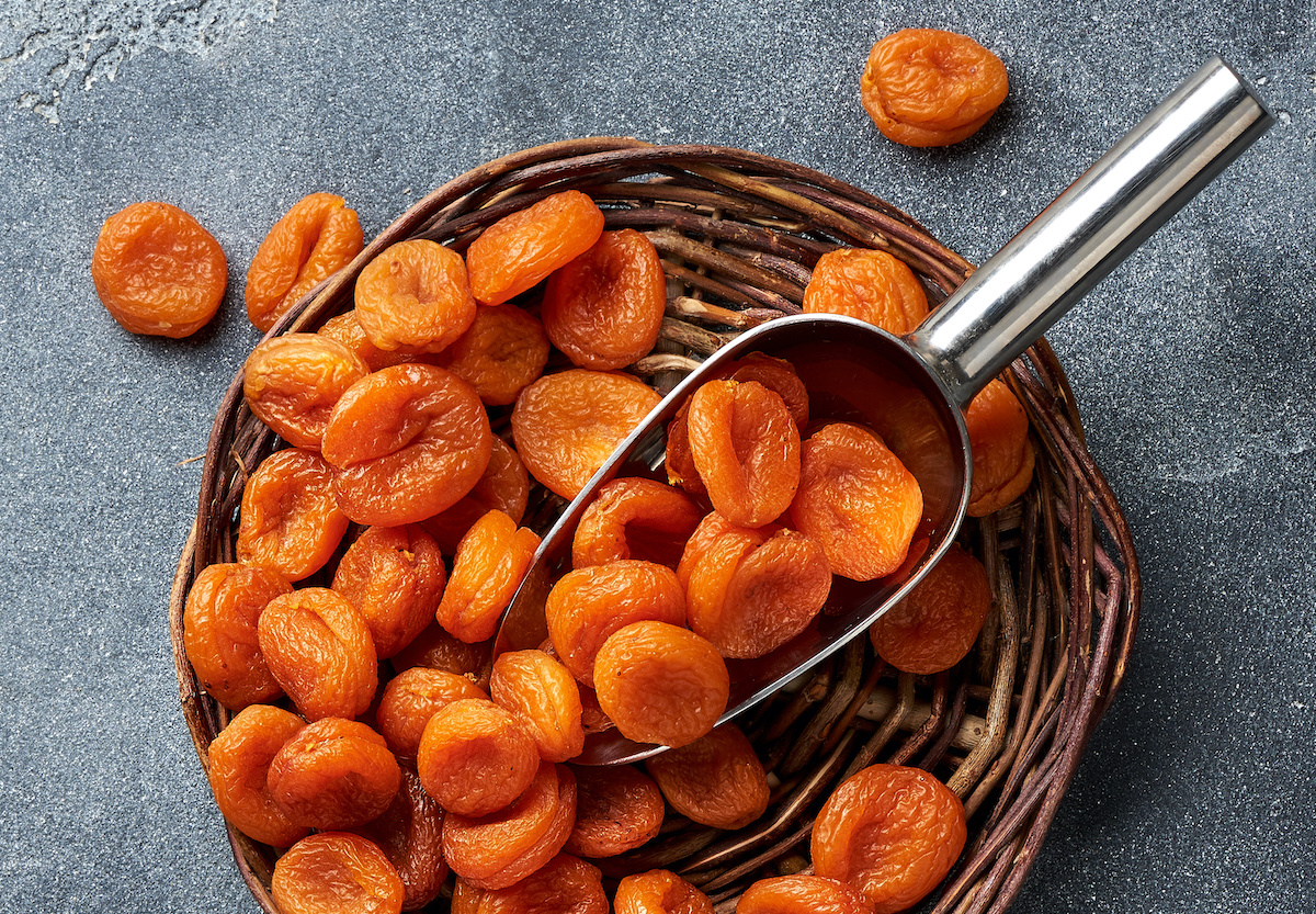 Dried apricots on gray background. Top view.